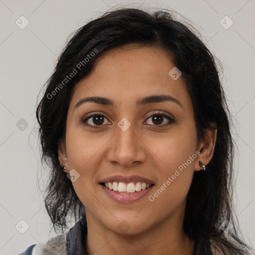 Joyful latino young-adult female with long  brown hair and brown eyes