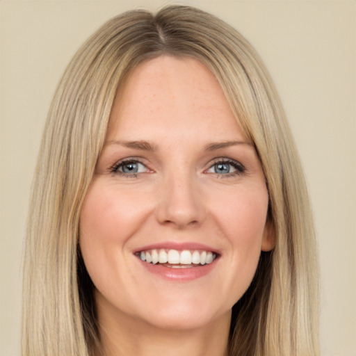 Joyful white adult female with long  brown hair and brown eyes