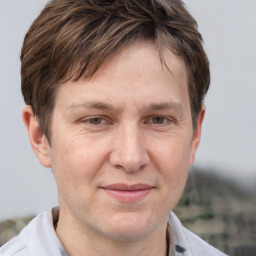 Joyful white adult male with short  brown hair and brown eyes