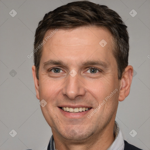 Joyful white adult male with short  brown hair and brown eyes