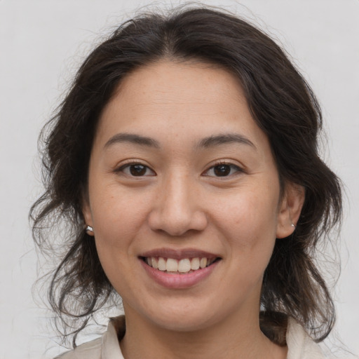 Joyful white young-adult female with medium  brown hair and brown eyes