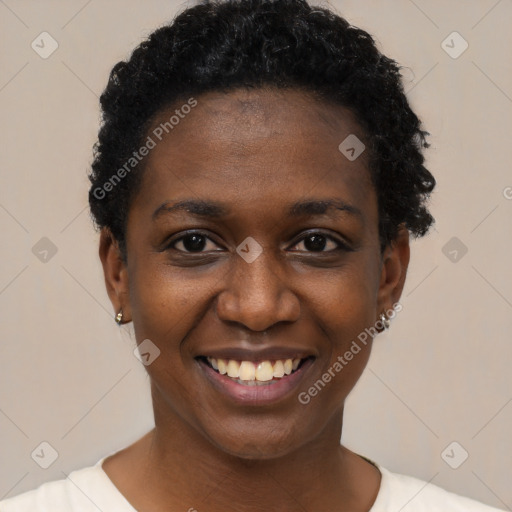 Joyful black young-adult female with short  black hair and brown eyes