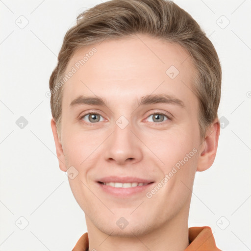 Joyful white young-adult male with short  brown hair and grey eyes