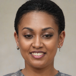 Joyful black young-adult female with short  brown hair and brown eyes