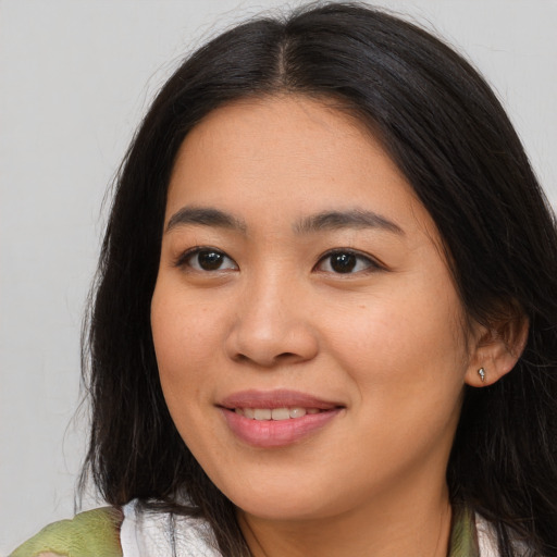 Joyful asian young-adult female with long  brown hair and brown eyes