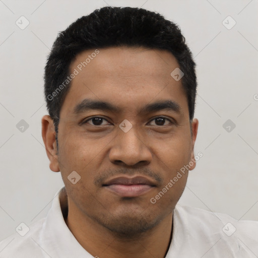 Joyful latino young-adult male with short  black hair and brown eyes