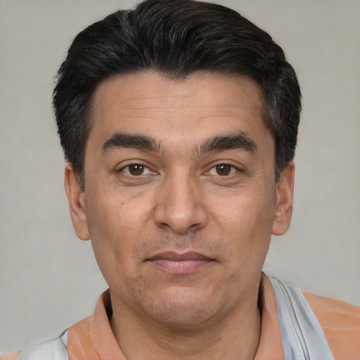 Joyful white adult male with short  black hair and brown eyes