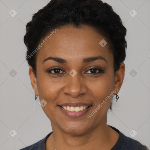 Joyful black young-adult female with short  black hair and brown eyes