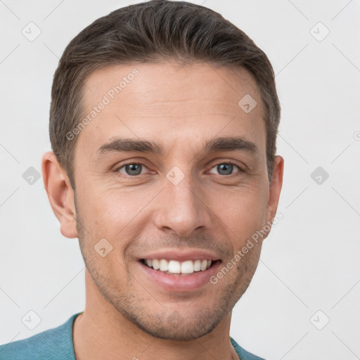 Joyful white young-adult male with short  brown hair and grey eyes