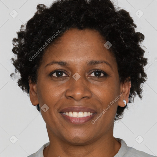 Joyful black adult female with short  brown hair and brown eyes