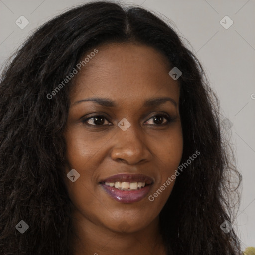 Joyful black young-adult female with long  brown hair and brown eyes