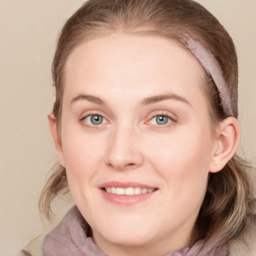 Joyful white young-adult female with medium  brown hair and blue eyes