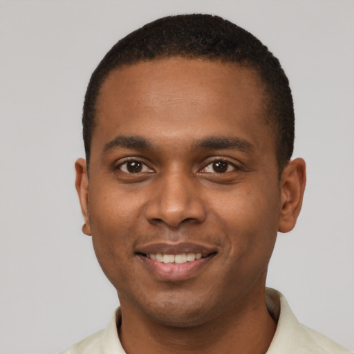 Joyful black young-adult male with short  black hair and brown eyes