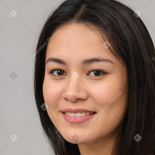 Joyful asian young-adult female with long  brown hair and brown eyes