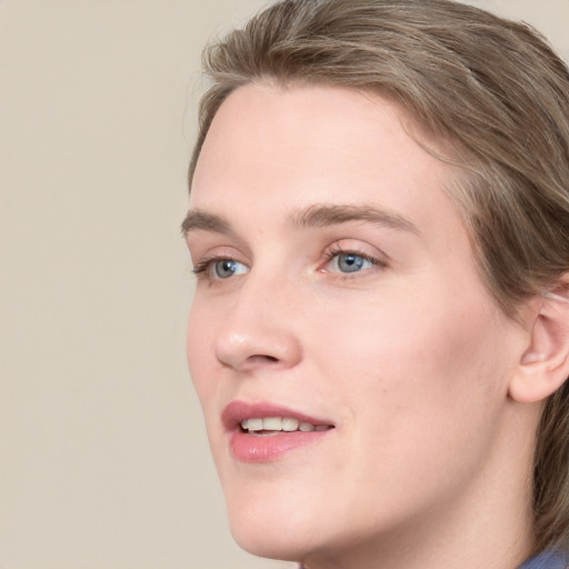 Joyful white young-adult female with medium  brown hair and blue eyes