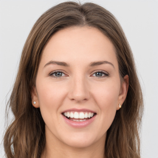 Joyful white young-adult female with long  brown hair and grey eyes