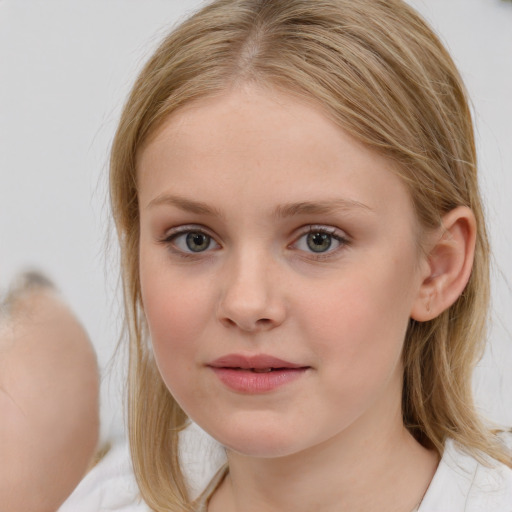 Joyful white child female with medium  brown hair and blue eyes