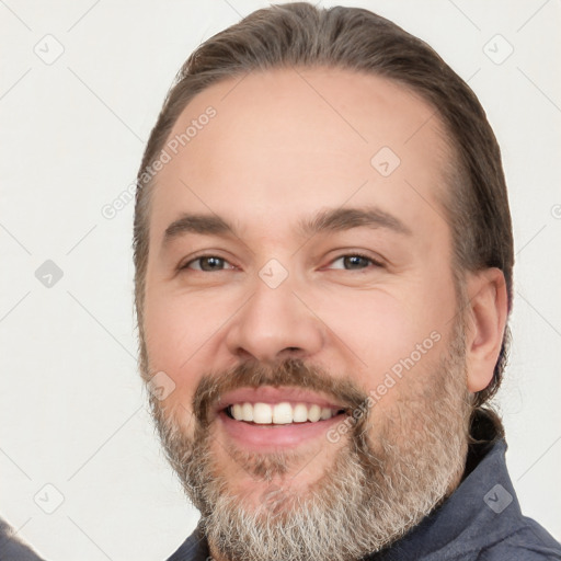 Joyful white adult male with short  brown hair and brown eyes