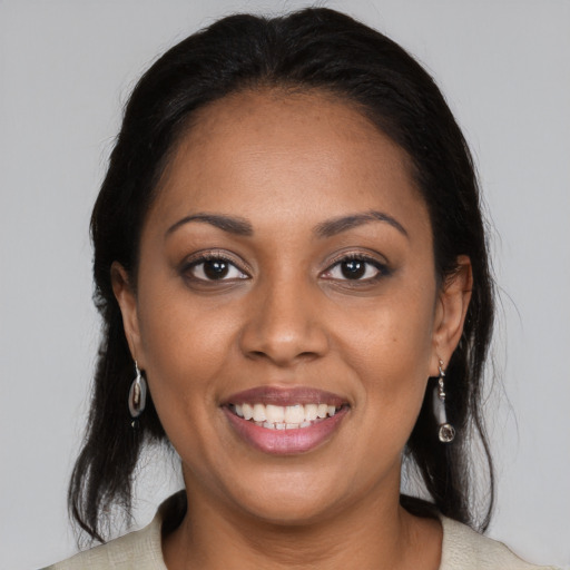 Joyful black young-adult female with medium  brown hair and brown eyes