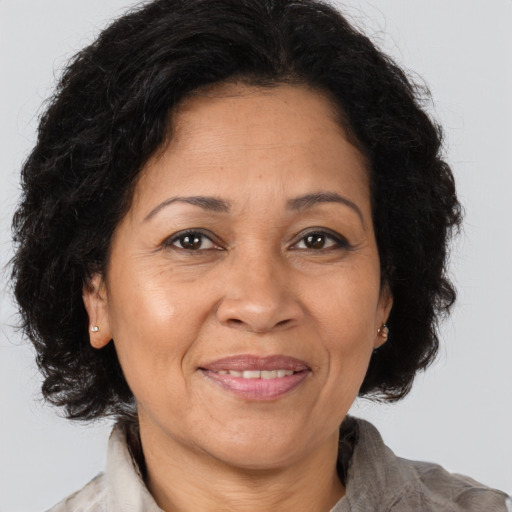 Joyful latino adult female with medium  brown hair and brown eyes