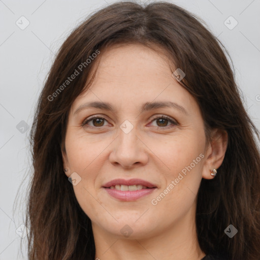 Joyful white adult female with long  brown hair and brown eyes