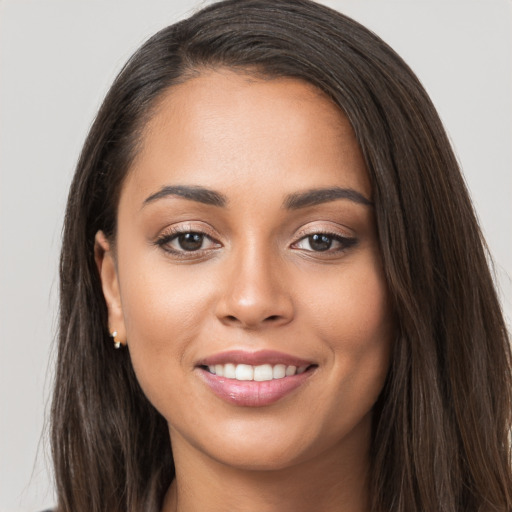 Joyful white young-adult female with long  brown hair and brown eyes