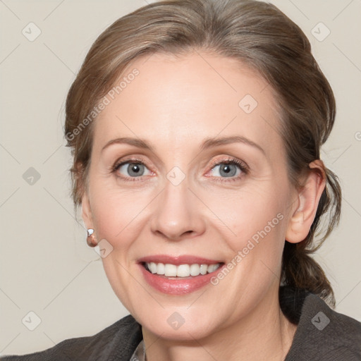 Joyful white adult female with medium  brown hair and blue eyes