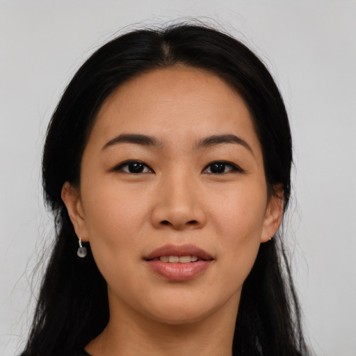 Joyful asian young-adult female with long  black hair and brown eyes