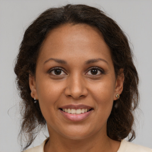 Joyful black young-adult female with medium  brown hair and brown eyes