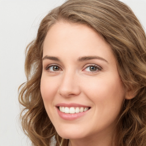 Joyful white young-adult female with long  brown hair and green eyes