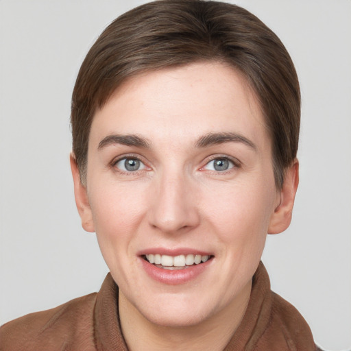 Joyful white young-adult female with short  brown hair and grey eyes