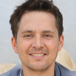 Joyful white adult male with short  brown hair and brown eyes