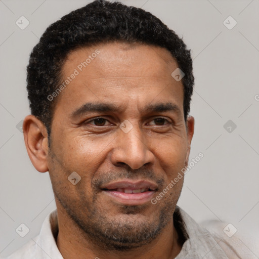 Joyful latino adult male with short  brown hair and brown eyes