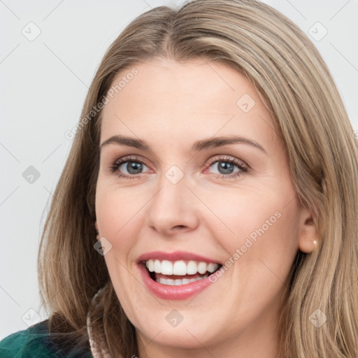 Joyful white young-adult female with medium  brown hair and green eyes