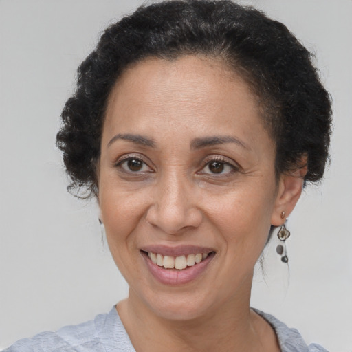 Joyful black adult female with short  brown hair and brown eyes