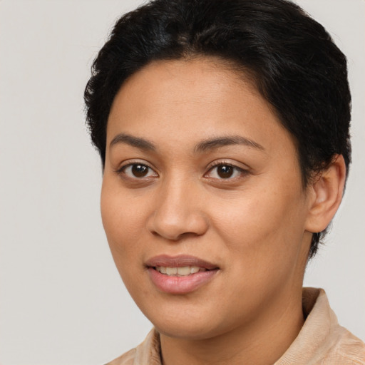 Joyful latino young-adult female with short  brown hair and brown eyes