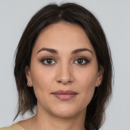 Joyful white young-adult female with medium  brown hair and brown eyes