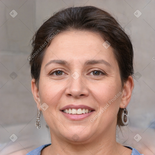 Joyful white adult female with medium  brown hair and grey eyes