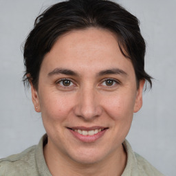 Joyful white young-adult female with medium  brown hair and brown eyes