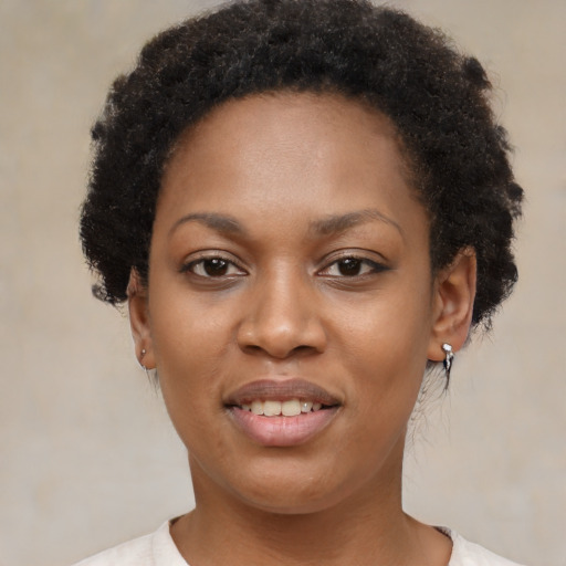 Joyful black young-adult female with short  brown hair and brown eyes