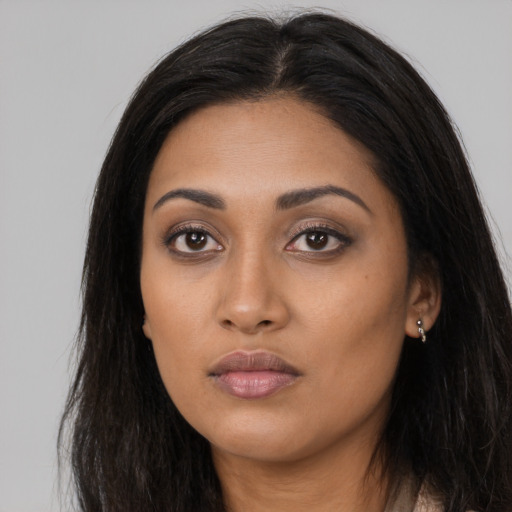 Neutral latino young-adult female with long  black hair and brown eyes