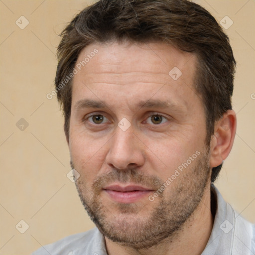 Joyful white adult male with short  brown hair and brown eyes