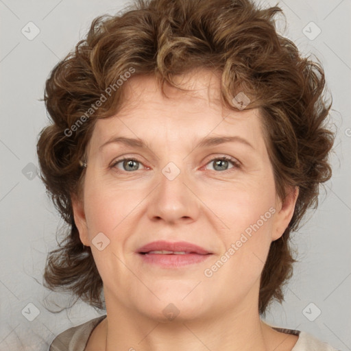 Joyful white adult female with medium  brown hair and blue eyes