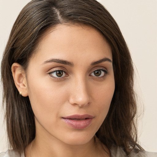 Neutral white young-adult female with long  brown hair and brown eyes