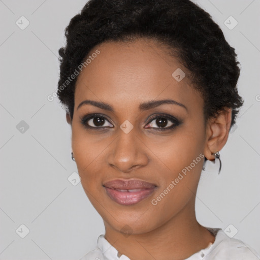 Joyful black young-adult female with short  black hair and brown eyes