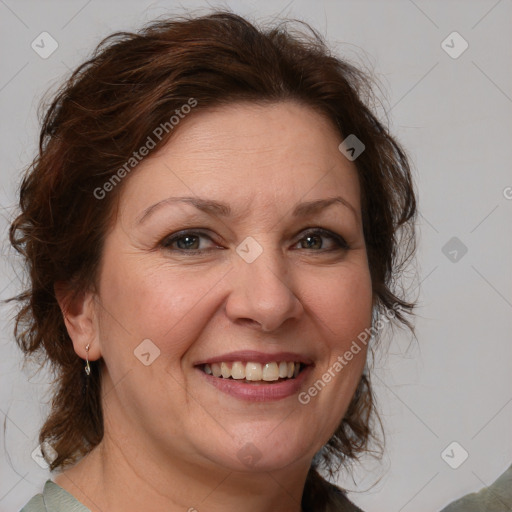 Joyful white adult female with medium  brown hair and blue eyes