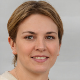 Joyful white young-adult female with short  brown hair and grey eyes