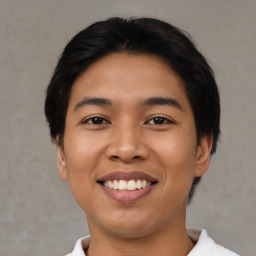 Joyful asian young-adult male with short  black hair and brown eyes