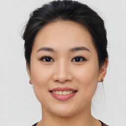 Joyful asian young-adult female with medium  brown hair and brown eyes