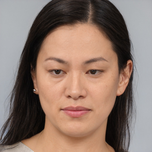 Joyful asian young-adult female with medium  brown hair and brown eyes